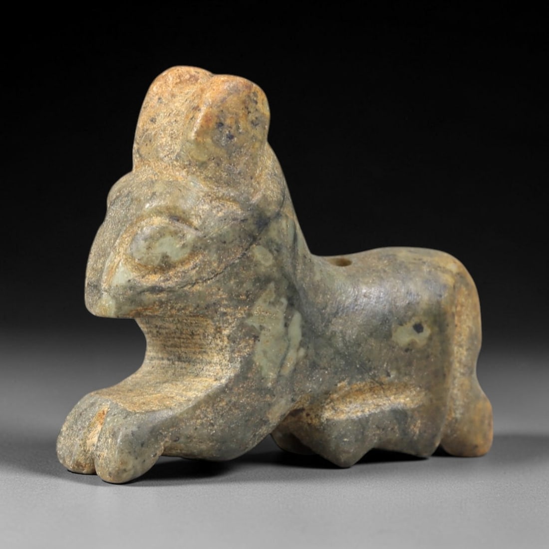 Ancient Stone Zoomorphic Feline - Near Eastern Amulet Figurine, 27AS: Carved from hardstone, this amulet depicts a striding zoomorphic feline form with stylized, angular features. The head is raised, with prominent incised eyes, a defined snout, and small upright ears,