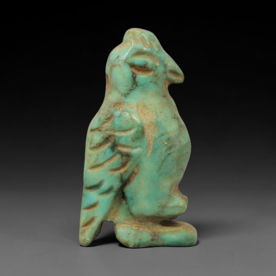 Ancient Turquoise Vulture - Near Eastern Amulet, 5XV: This artifact is a carved turquoise vulture, crafted with simplified yet expressive relief detailing that captures the iconic form of the vulture, a symbol with significance in ancient Near Eastern ic