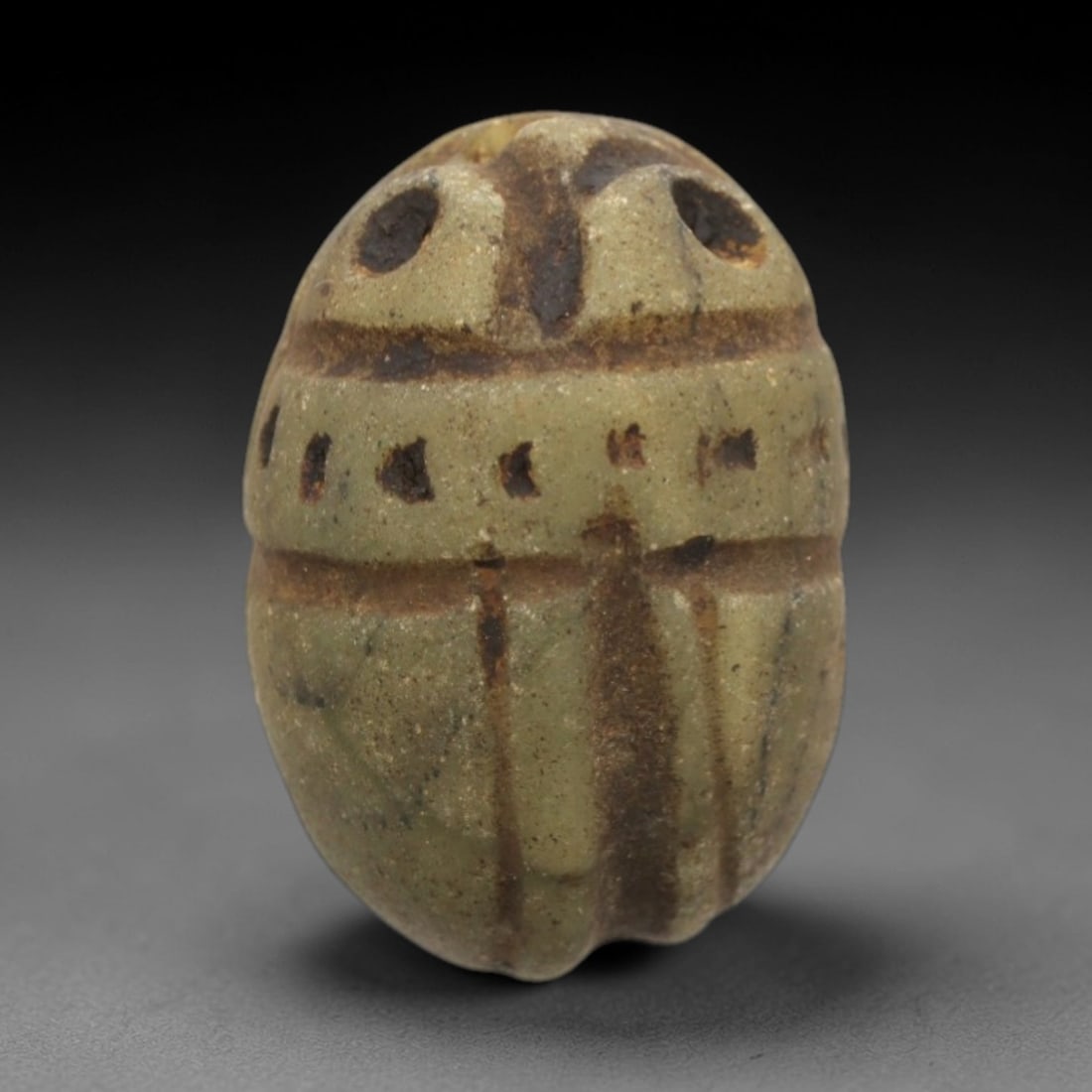 Ancient Steatite Scarab Stamp Seal - Near Eastern Anthropomorphic Figure, 31ZS: Carved from pale green steatite with dark brown incised patination, this Near Eastern scarab stamp seal features a dorsal scarab pattern with linear elytra segments and decorative perforations, while
