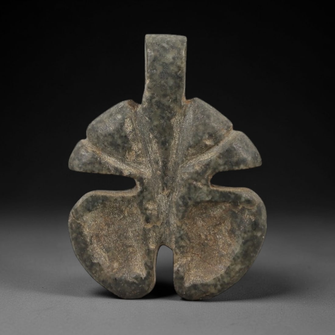 Ancient Egyptian Stone Amulet - Trefoil Carving, 80AG: Carved from stone, this ancient Egyptian amulet features a trefoil (three-lobed) form with incised detailing, a design typical of protective amulets from the Late Period (c. 664-332 BCE). The trefoil