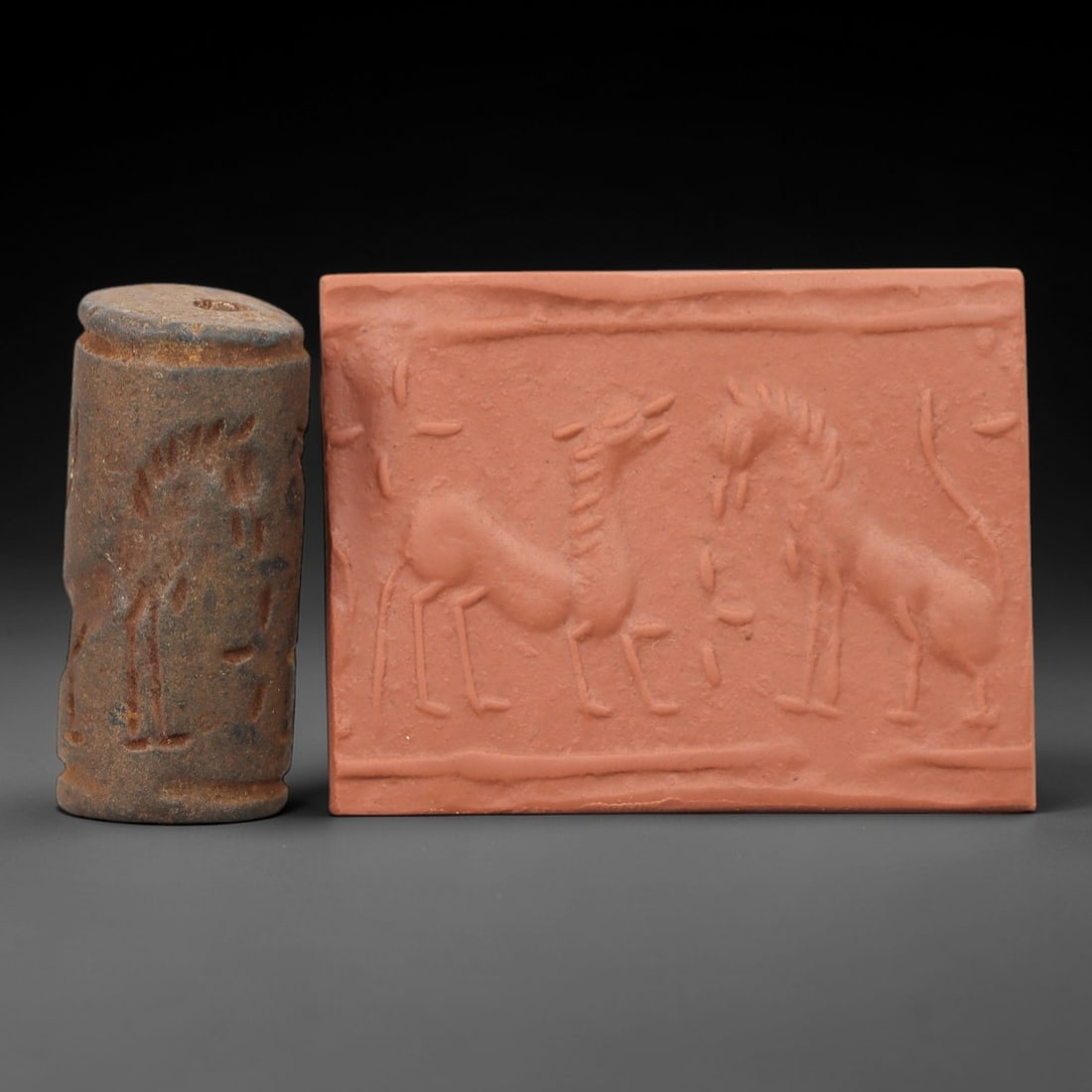Ancient Steatite Cylinder Seal - Mesopotamian Animal Scene, 1ZP: Carved from weathered steatite, this ancient Mesopotamian cylinder seal depicts a stylized animal scene, executed with the characteristic glyptic simplicity of Mesopotamian Bronze Age art. The cylindr