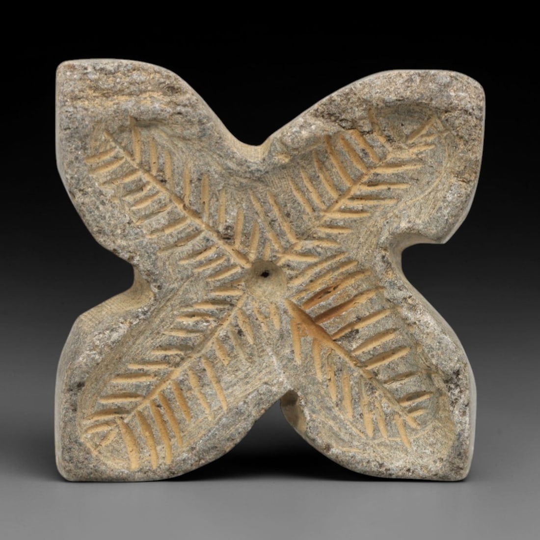 Ancient Greco-Bactrian Stone Stamp Seal - Four-Petal Floral Artifact, 16ZR: This artifact is a four-petal stone stamp seal, executed in the Greco-Bactrian decorative tradition of Central Asia. The face features a symmetrical four-petal floral motif, with incised feather-like