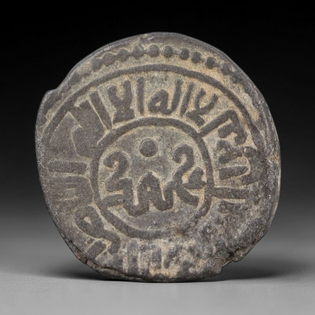 MONGOL EMPIRE: Ilkhanid - Islamic Caliphate Bronze Coin, 13th-14th Century, 15mm, 7AP: This compact bronze coin from the Mongol Empire bears witness to the fusion of steppe imperial power and Islamic statecraft that reshaped the medieval world. Its surface is adorned with flowing Arabic