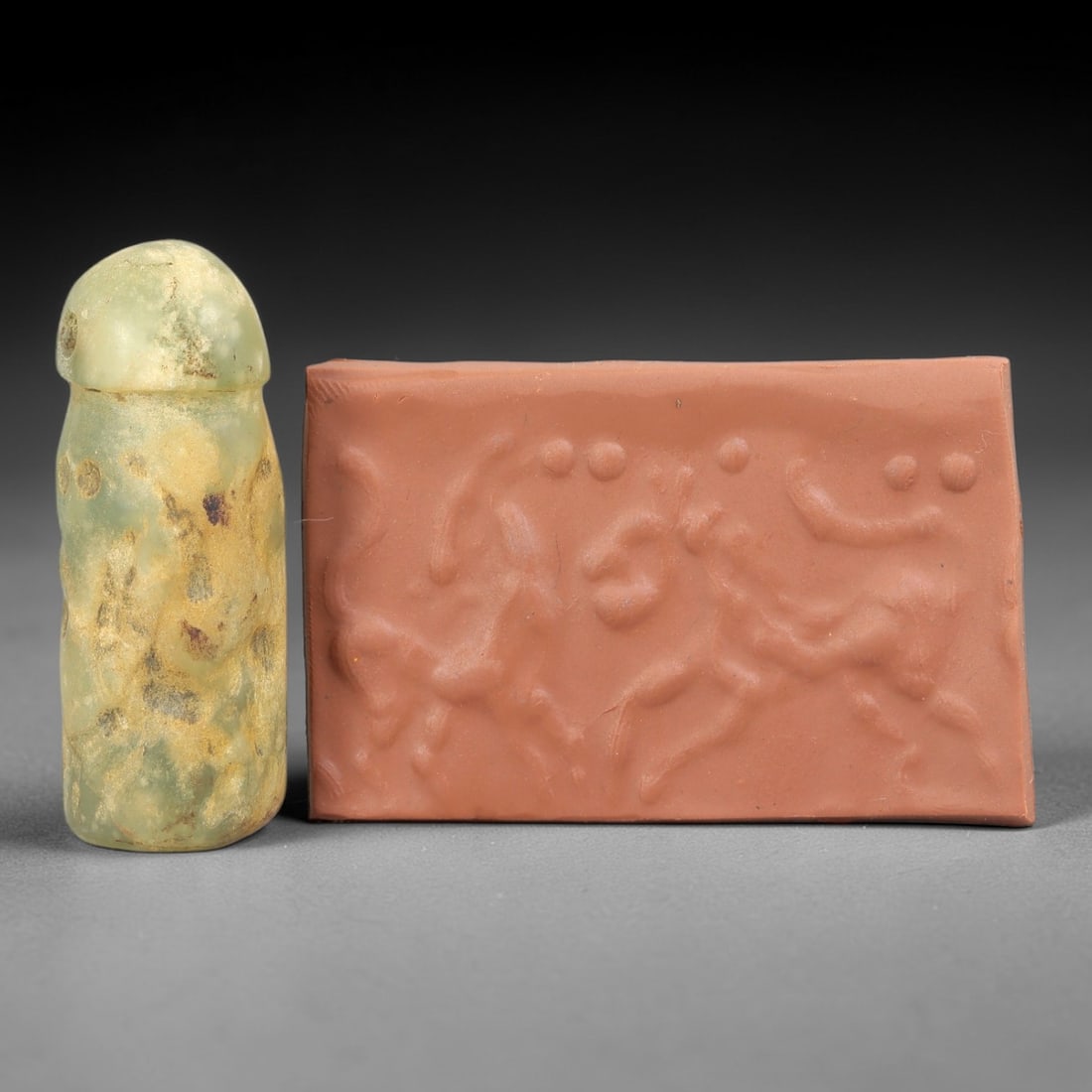 Ancient Serpentine Cylinder Seal - Mesopotamian Hunting Motif, 78FX: Carved from serpentine, this cylinder seal follows the classic cylindrical form of ancient Mesopotamian administrative and ritual artifacts. Its surface bears a dynamic narrative scene depicting a hun