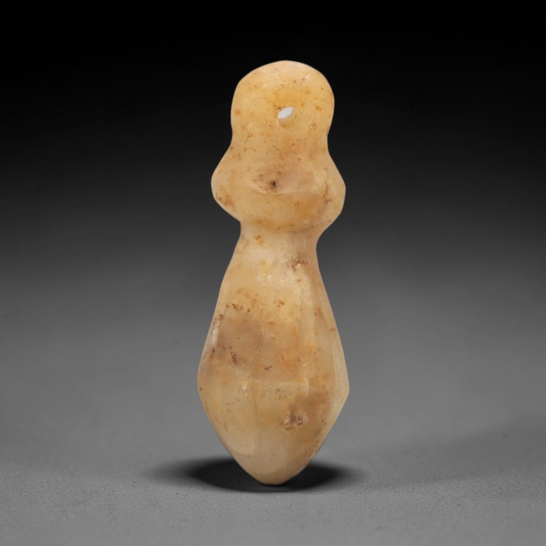 Ancient Chalcedony Amulet - Egyptian Figurine, 87XS: Carved from smooth, pale yellow chalcedony with natural surface inclusions and subtle tonal variations, this amulet is formed as a stylized vegetal or fertility symbol with incised linear detailing to