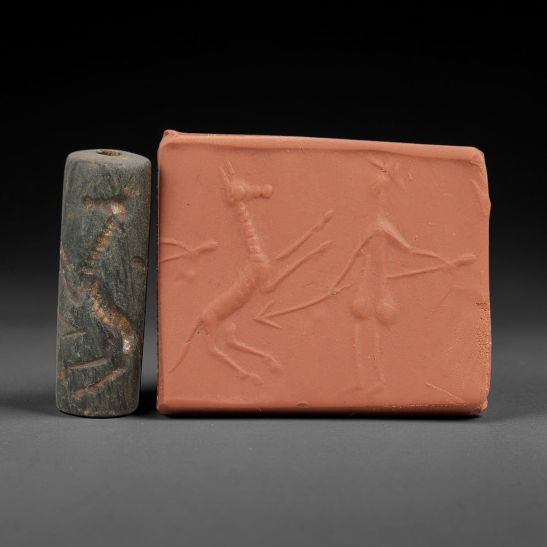 Ancient Near Eastern Stone Cylinder Seal - Horse Motif, 65AH: Carved from fine-grained stone, this cylinder seal features incised depictions of equine figures with detailed rendering of manes and limbs, a motif characteristic of ancient Near Eastern glyptic art.