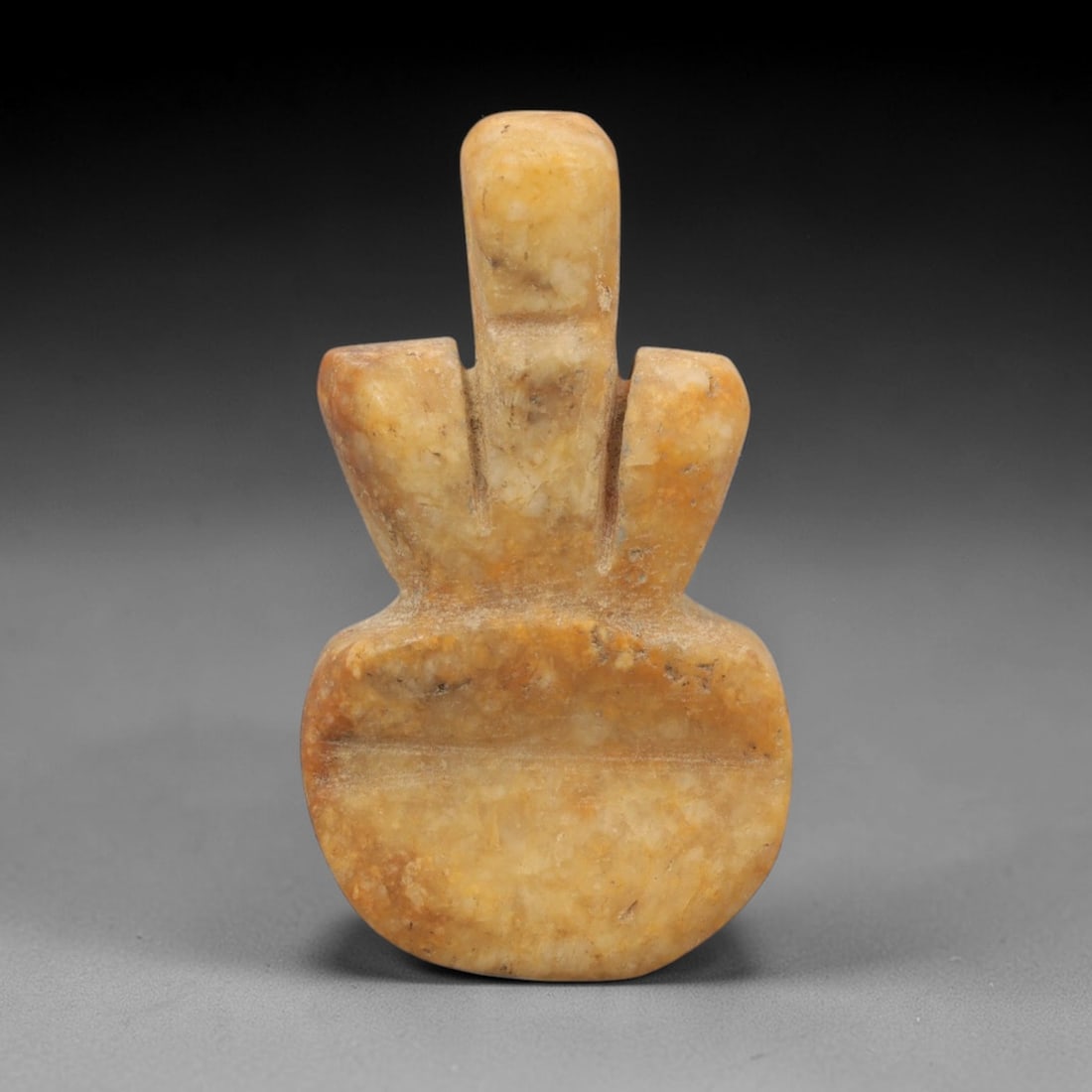 Ancient Calcite Anthropomorphic Amulet - Near Eastern Figurine, 44ZW: This amulet is carved from mottled golden-brown calcite, featuring a stylized anthropomorphic form with a rectangular head, simplified torso, and rounded base. Incised vertical lines define the neck a