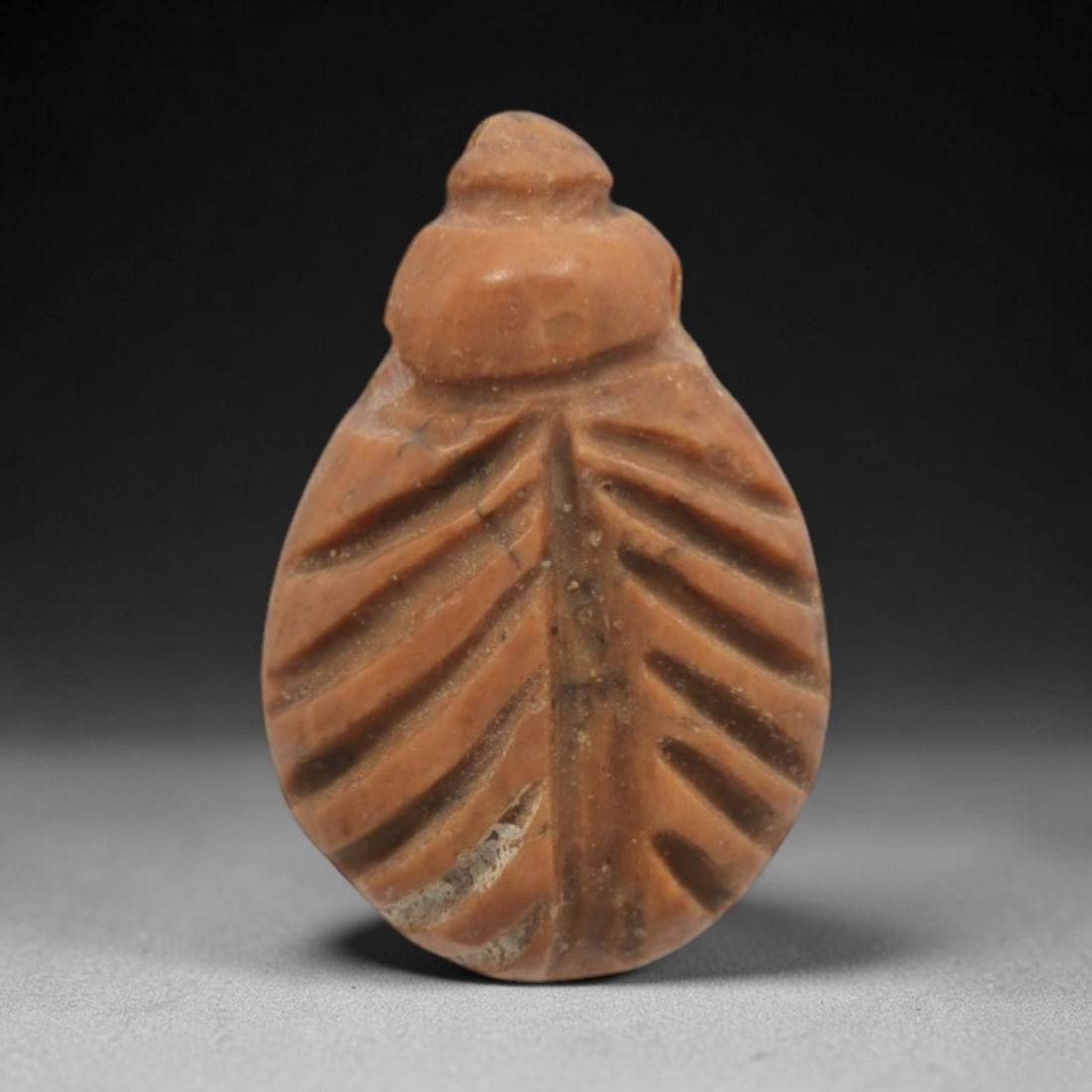 Ancient Stone Scarab - Egyptian Amulet Figurine, 50ZW: This amulet is carved from warm terracotta-colored stone, formed into the classic scarab beetle shape, a potent symbol of rebirth and protection in ancient Egyptian cosmology. Incised linear patterns