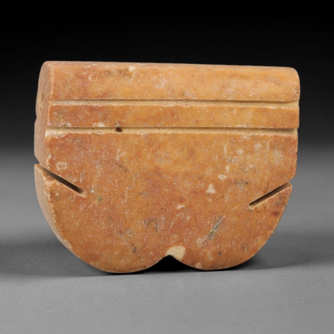 Ancient Egyptian Stone Amulet - Geometric Carved Pendant, 78AE: Carved from stone, this ancient Egyptian amulet features a geometric pattern with linear carvings, a design typical of protective amulets from the Late Period. The compact pendant has a suspension hol