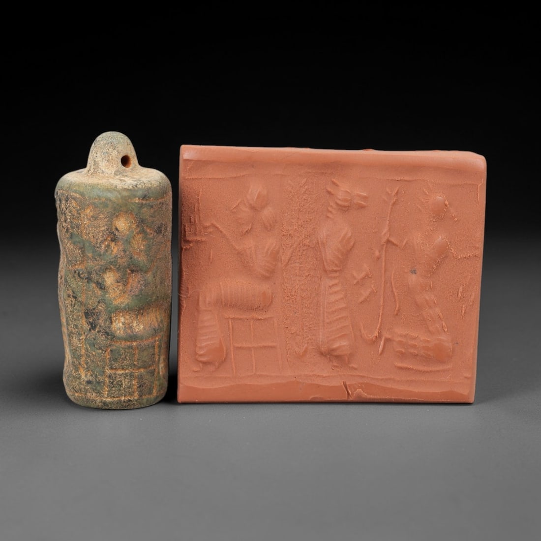 Ancient Serpentine Cylinder Seal - Near Eastern Glyptic Art, 84AJ: Carved from serpentine stone, this ancient Near Eastern cylinder seal features a cylindrical form with raised relief carvings depicting human figures and geometric patterns. The seal exhibits fine gly