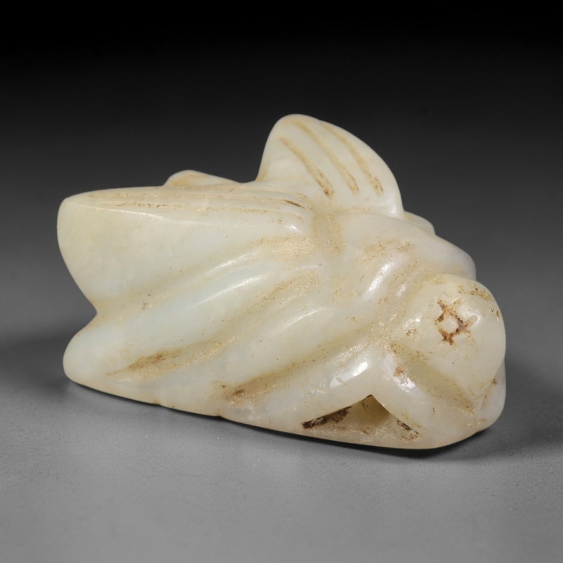 Ancient Chalcedony Fly Amulet - Egyptian Figurine, 40AR: This artifact is carved from pale, milky-white chalcedony, exhibiting a smooth, polished surface with subtle natural inclusions and faint surface wear consistent with age. The form is a stylized fly a