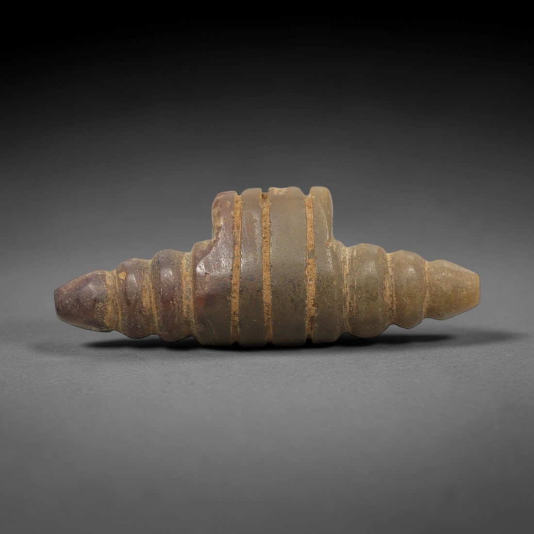 Ancient Stone Panther - Near Eastern Animal Amulet, 62ZR: Carved from light beige speckled stone with a naturally weathered, matte patina, executed in a stylized, compact form characteristic of Near Eastern animal amulet craftsmanship. The figure depicts a r