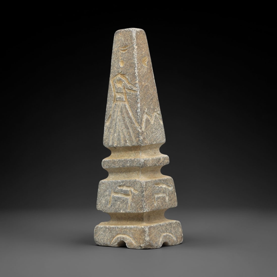 Ancient Schist Kohl Vessel - Figural and Symbolic Inscriptions, 72ZP: This tapered kohl vessel is carved from schist, featuring a stepped hexagonal base and a pyramidal upper section, decorated with incised figural and symbolic inscriptions: a standing robed figure with