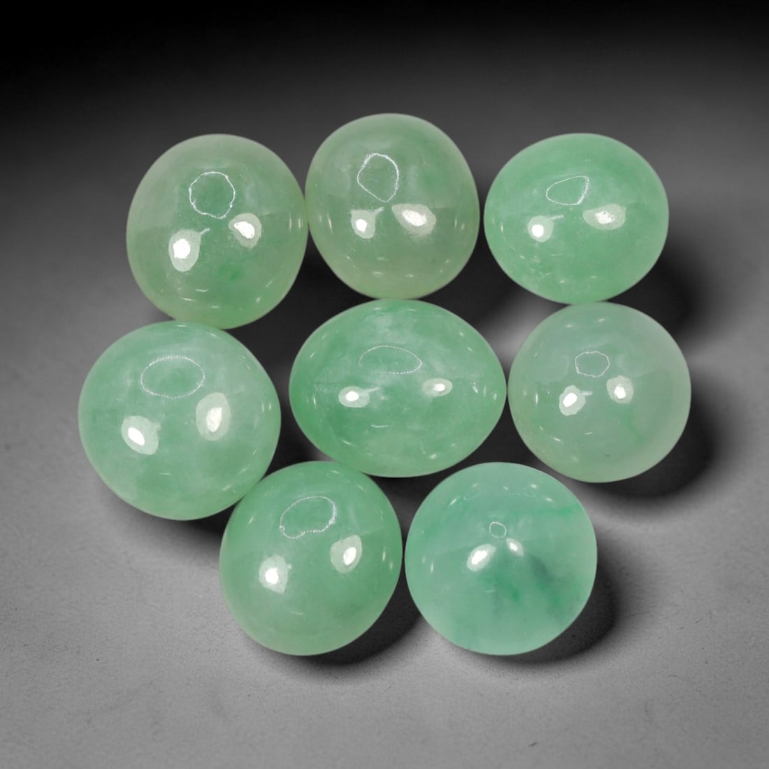 Natural Type A Jadeite Jade - Loose Cabochon Gemstone, 5AP: Crafted from natural Type A jadeite jade, these eight cabochons exhibit a translucent pale green hue with subtle tonal variations inherent to the material. Each stone is cut en cabochon with a smooth,