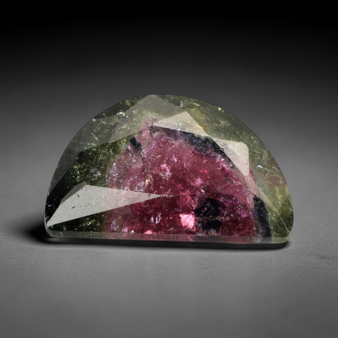 6.47 Carats Watermelon Bi-Color Tourmaline Half-Moon Fancy - Natural Nigerian Stone, 34XP: This striking half-moon fancy-cut tourmaline showcases a vivid watermelon bi-color pattern, with a deep raspberry-pink core framed by a crisp, pale olive-green border. Measuring precisely at 16.8 x 10