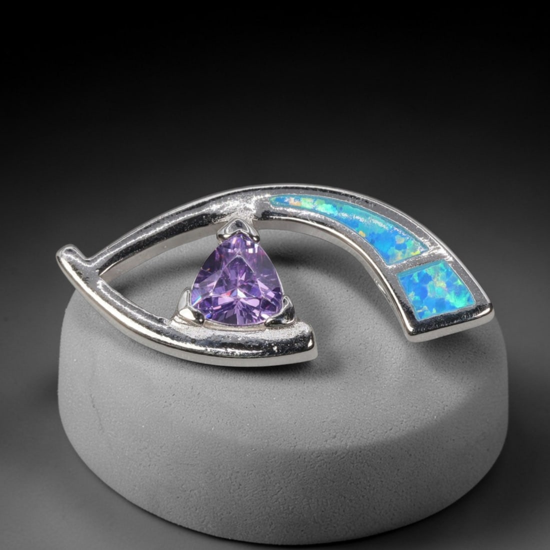 4.27g 925 Sterling Silver Eye Pendant - Simulated Opal Amethyst, 42D: Crafted from stamped 925 sterling silver, this pendant features a stylized openwork eye design with a sleek, modern silhouette. A trillion-cut deep purple amethyst-colored gemstone is secured at the c