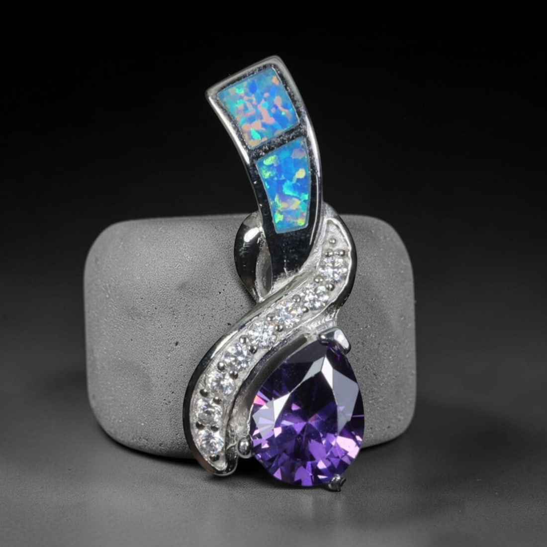 3.68g 925 Sterling Silver Swirl Pendant - Simulated Opal Amethyst, 43D: Crafted from stamped 925 sterling silver, this pendant features an elegant swirling openwork design. Two rectangular segments of simulated opal are inlaid along the upper curved silver band, exhibitin