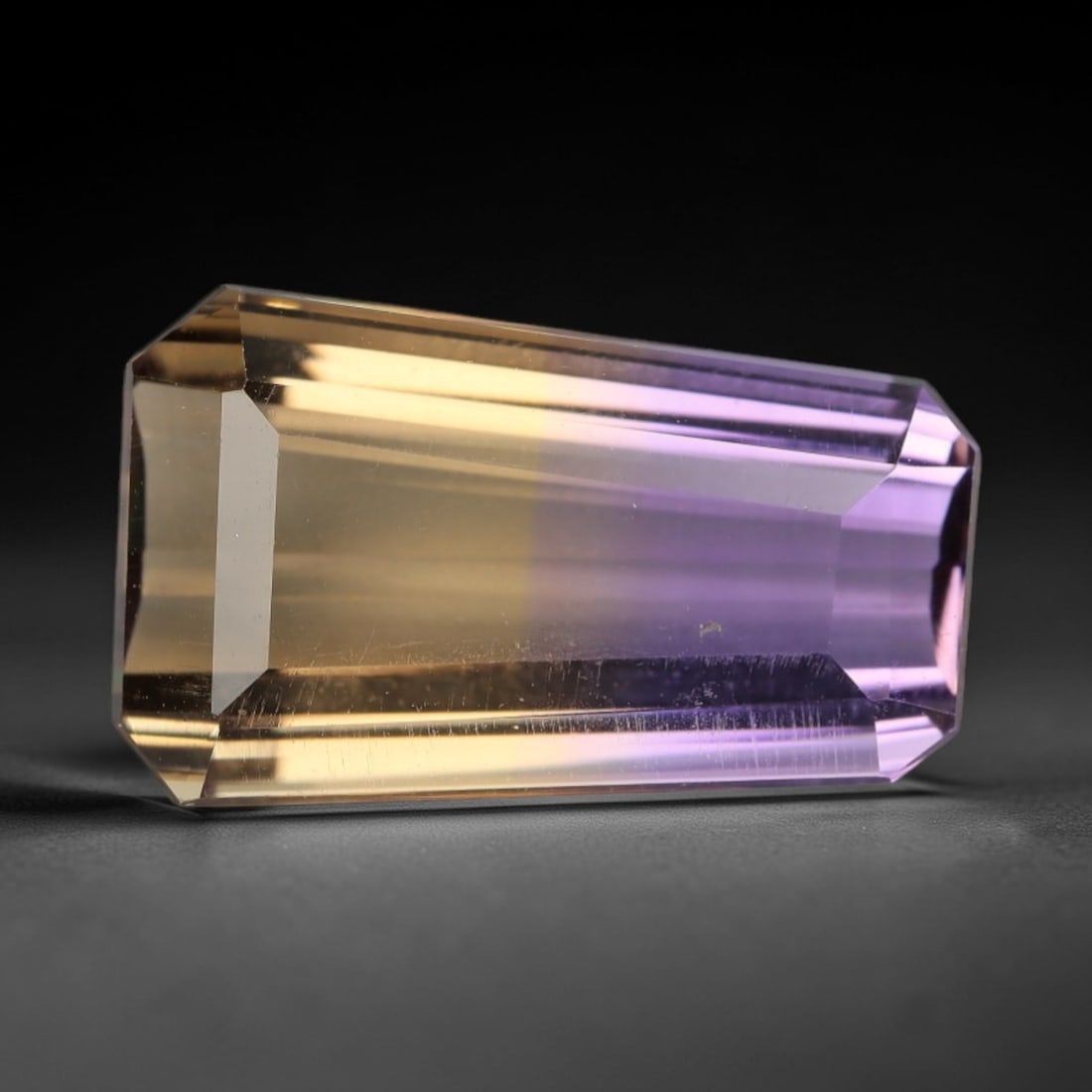 7.493 Carats Violet and Yellow Ametrine - Natural Bolivian Gemstone, LZ280: This exceptional 7.493 carat octagon step-cut ametrine presents a masterful fusion of saturated violet and warm golden-yellow hues, with a crisp, well-defined color boundary that is the hallmark of pr