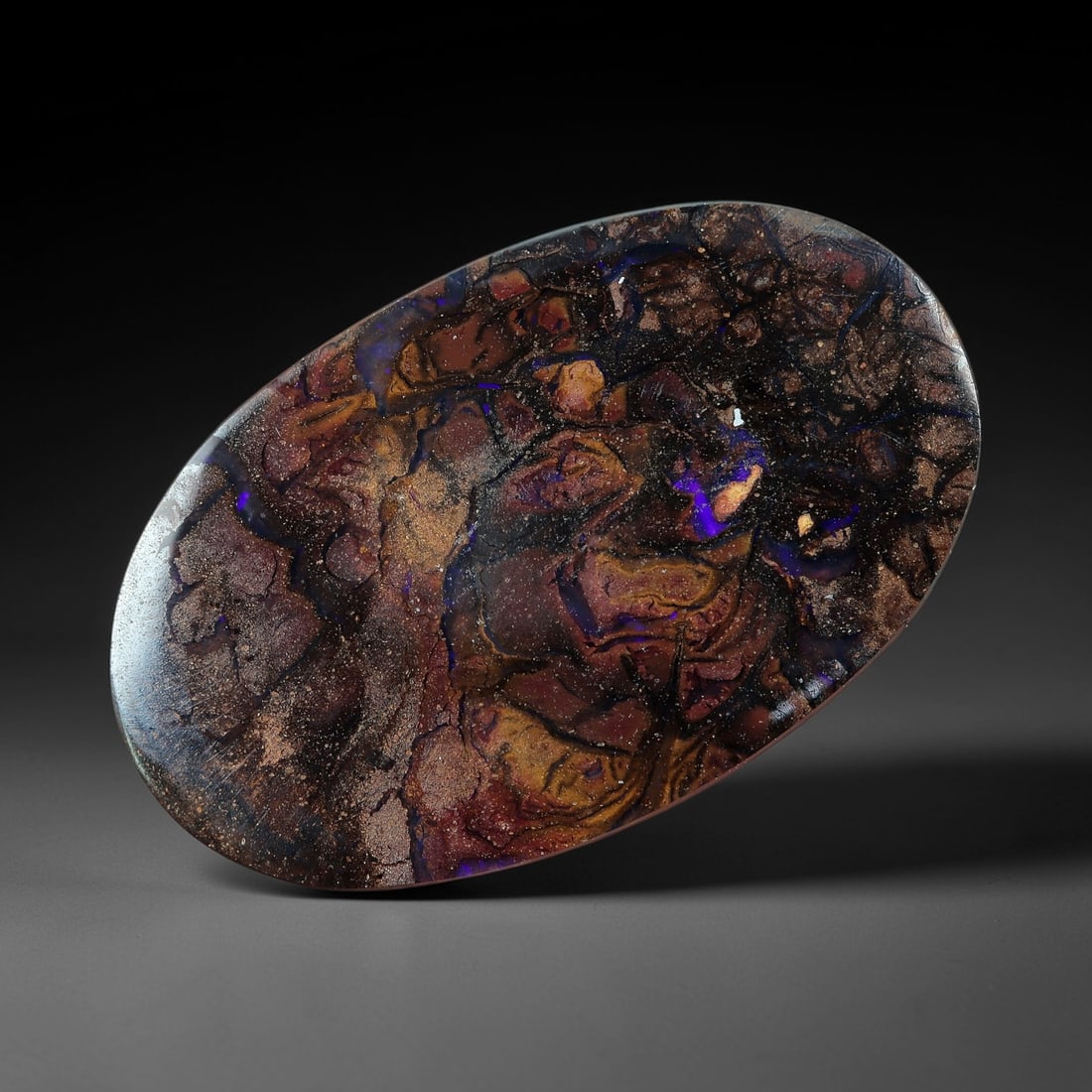 6.09 Carats Koroit Yowah Opal Cabochon - Natural Australian Single Stone, 84XL: This exceptional Koroit Yowah opal cabochon, calibrated to 17.3x10.7mm, features a dense, textured ironstone matrix in layered tones of deep chocolate brown, bronze, and jet black. Scattered throughou