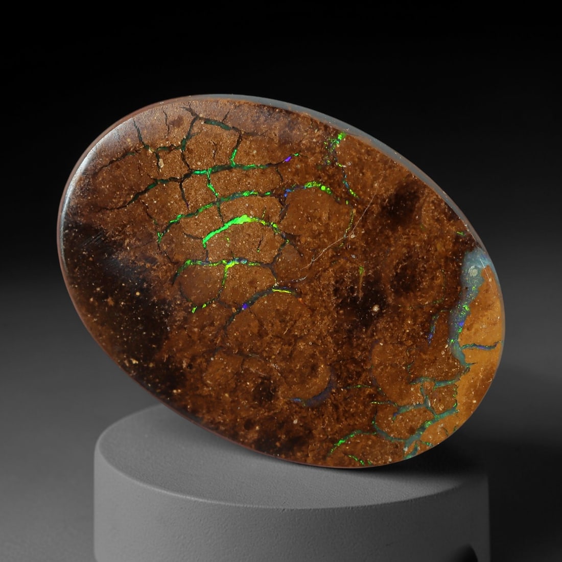 3.52 Carats Koroit Yowah Opal Cabochon - Natural Australian Single Stone, 82XL: This striking Koroit Yowah opal cabochon, measuring 13.3x9.7mm, features a rich, earthy brown ironstone matrix crisscrossed by a network of vivid, iridescent opal veins. The opal inclusions emit inten