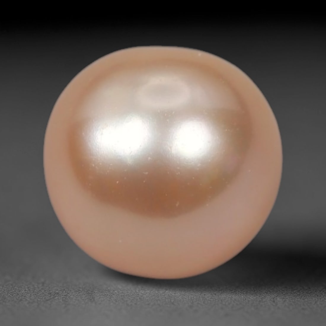 2.41 Carats 6.8mm Round Freshwater Pearl - Natural Loose Gemstone, 23XP: This perfectly spherical 6.8mm freshwater pearl radiates a soft, warm pinkish-peach hue with a delicate pearlescent luster that captures light in gentle, iridescent flashes. Its smooth, unblemished su