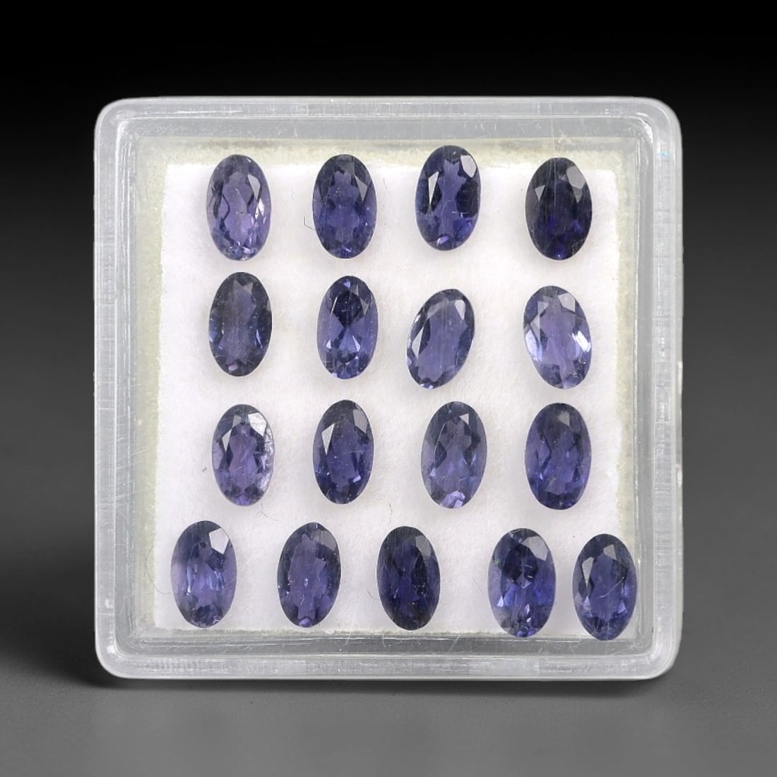 3.19 Carats Oval Mixed-Cut Iolite Parcel - Natural Iolite 5x3mm, 70XM: This parcel of oval mixed-cut iolites showcases a rich, deep blue-purple hue, reminiscent of twilight skies, with subtle silvery undertones that lend a luminous, ethereal appearance to each stone. The