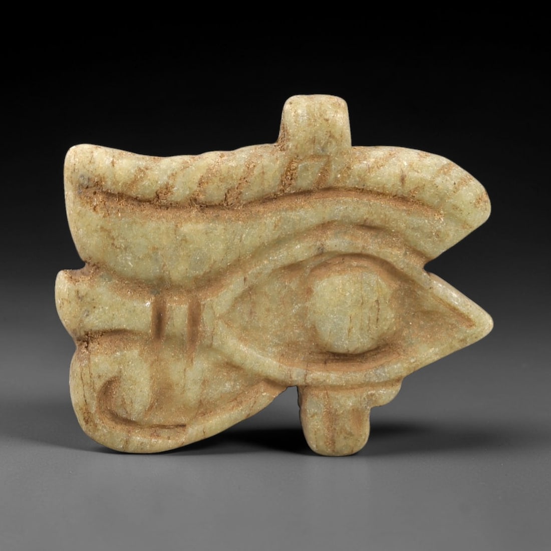 Ancient Egyptian Wedjat Eye Amulet - Green Stone Protective Talisman, 100AL: This amulet is carved from pale green stone with natural veining and a weathered patina, depicting the iconic **Wedjat Eye (Eye of Horus)**-a core symbol of ancient Egyptian spirituality. The piece fe