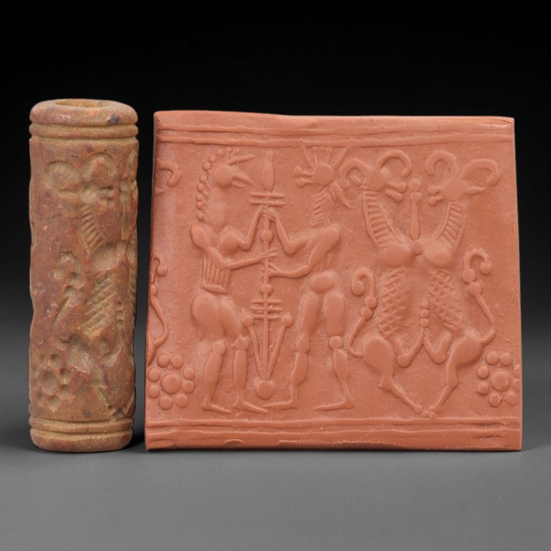 Ancient Steatite Cylinder Seal - Mesopotamian Hero Scene, 25ZP: Carved from warm, earthy steatite, this ancient Mesopotamian cylinder seal depicts a dynamic heroic scene, executed with precise glyptic craftsmanship characteristic of Mesopotamian Bronze Age art. Th