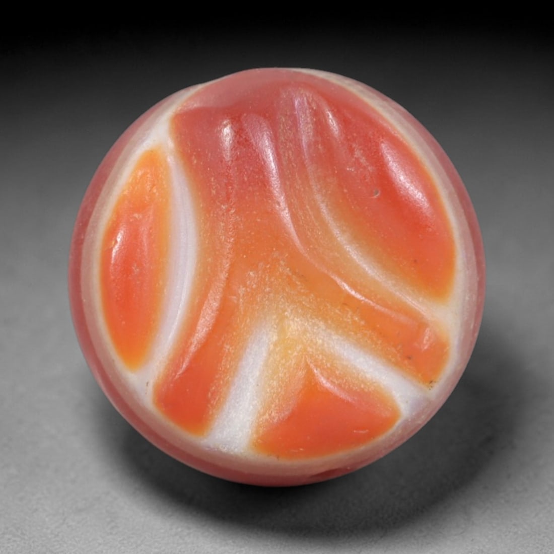Antique Agate Swirl Bead - Central Asian Gemstone Pendant, 4AR: Carved from banded agate with a soft pinkish base and flowing orange-white swirl patterns, this bead features a smooth spherical form with a lateral perforation for wearability. The natural agate band