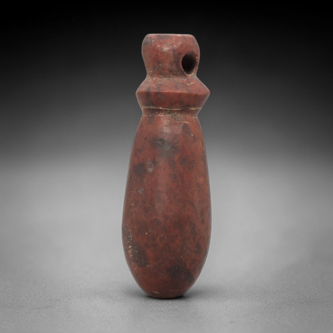 Ancient Near Eastern Red Stone Pear-Form Amulet - Carved Pendant Figure, 4ZV: This amulet is carved from a rich, deep red stone with natural mineral speckling and patination, likely brecciated jasper or red steatite, featuring an elegant pear-form (or teardrop) shape. The piece