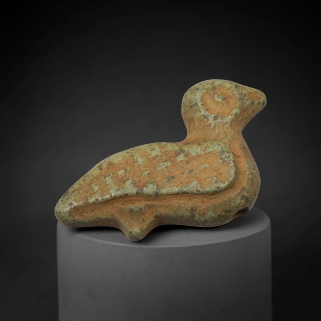 Ancient Green-Brown Stone Bird-Form Amulet - Near Eastern Miniature Figurine, 96XP: Carved from a weathered green-brown stone with natural mineral speckling and earthy patination, this charming amulet depicts a stylized recumbent bird, a beloved motif in ancient Near Eastern ritual a