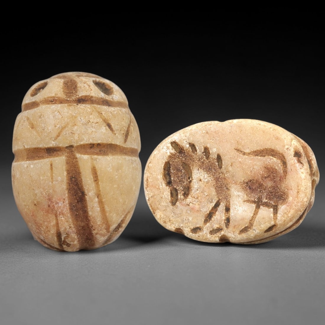 Ancient Steatite Scarab Stamp Seal - Near Eastern Horse Figure, 88AM: Carved from pale beige steatite with natural brown banding, this Near Eastern scarab stamp seal features a dorsal scarab pattern with incised linear details defining the elytra and decorative segments