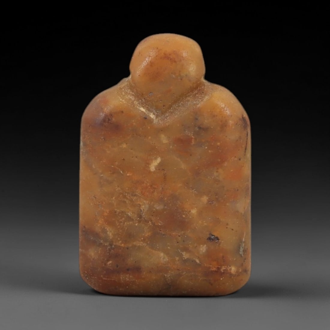 Ancient Egyptian Stone Amulet - Anthropomorphic Carved Pendant, 55AG: Carved from stone, this ancient Egyptian amulet features an anthropomorphic form with detailed linear carvings, typical of protective amulets from the Late Period. The compact pendant has a suspension