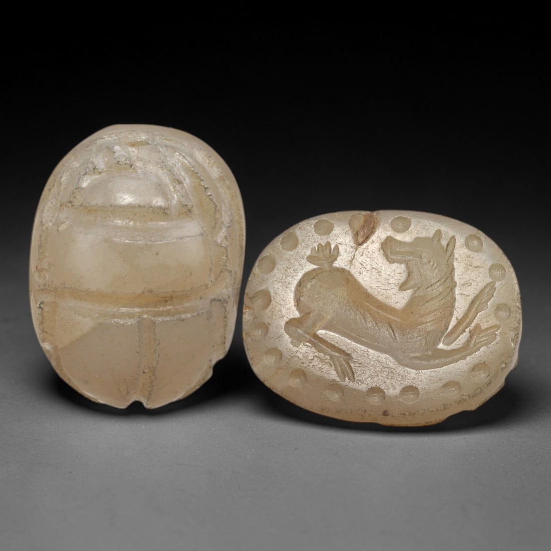 Ancient Chalcedony Scarab - Near Eastern Canine Zoomorphic Seal, 37XT: This artifact is hand-carved from pale translucent chalcedony, utilizing traditional ancient seal craftsmanship consistent with Near Eastern or Phoenician Iron Age traditions. The object takes the for