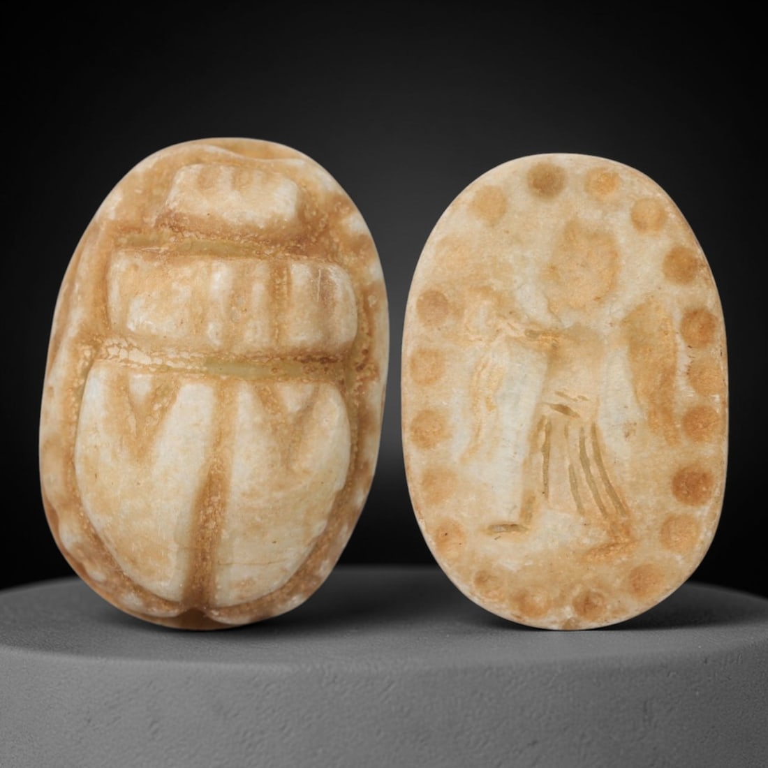 An Ancient Near Eastern Stone Scarab Stamp Seal, 1st Millennium BCE, 6ZM: Carved from pale, translucent stone with natural surface patination and subtle tonal variation, the object is formed as an oval scarab seal. The dorsal side is modeled in low relief with a segmented c