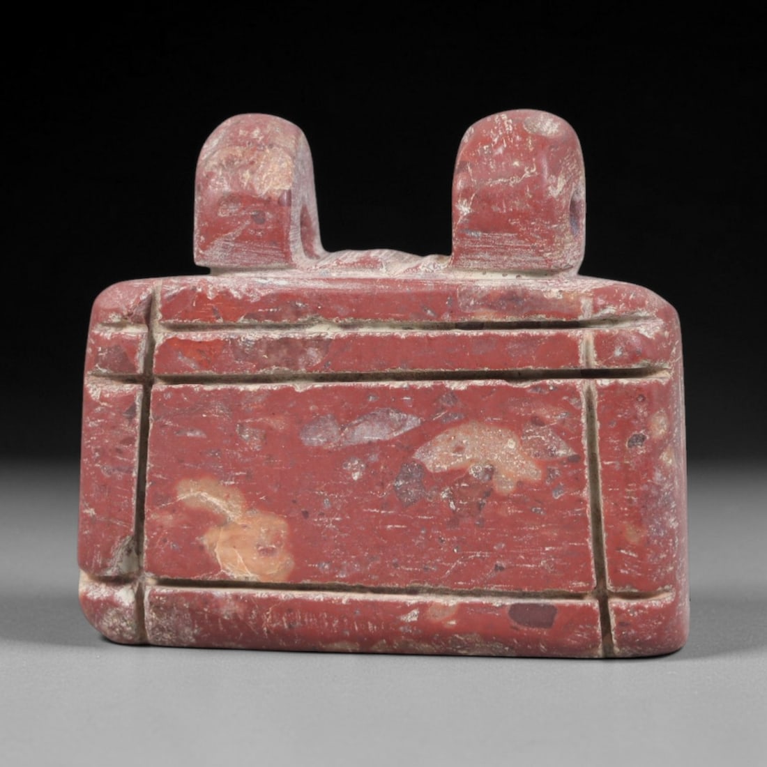 Ancient Stone Amulet - Egyptian Ritual Pendant, 39AP: This artifact is carved from variegated red stone with a weathered, earthy patina and natural mineral inclusions, exhibiting precise incised linear detailing consistent with ancient Egyptian stonework