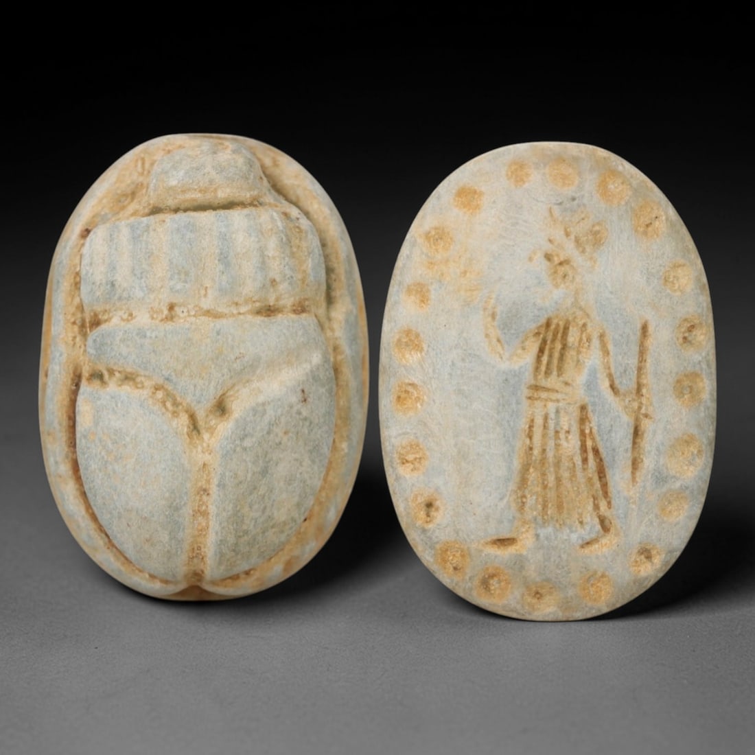 An Ancient Near Eastern Stone Scarab Stamp Seal, 1st Millennium BCE, 15ZM: Carved from pale, weathered stone with natural surface encrustation and subtle tonal variation, the object is formed as an oval scarab seal. The dorsal side is modeled in low relief with a segmented c
