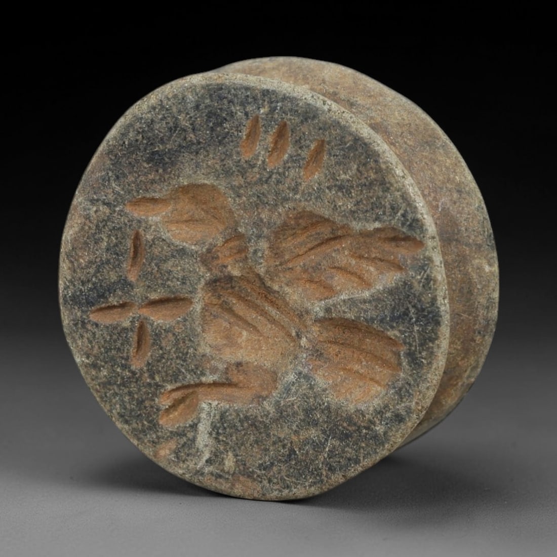 Ancient Stone Amulet - Near Eastern Stamp Seal Figurine, 21AH: Carved from stone, this ancient Near Eastern double convex stamp seal amulet features a stylized bird motif typical of early glyptic art in the region. The piece exhibits precise linear detailing and
