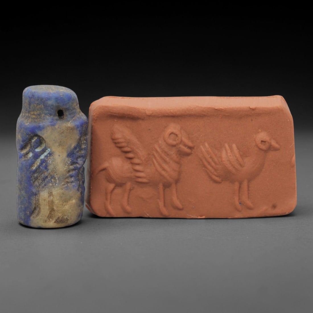 Ancient Lapis Lazuli Cylinder Seal - Near Eastern Glyptic Art, 45ZQ: Carved from lapis lazuli stone, this ancient Near Eastern cylinder seal features a cylindrical form with raised relief carvings depicting stylized animal and geometric motifs. The seal exhibits fine g