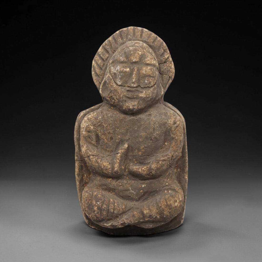 Edo Period Stone Monk - Japanese Antique Figurine, 69ZV: Carved from a weathered stone, this figurine depicts a seated Edo period Buddhist monk in meditative lotus position with hands clasped in prayer, featuring a radiating nimbus framing the head. Stylist