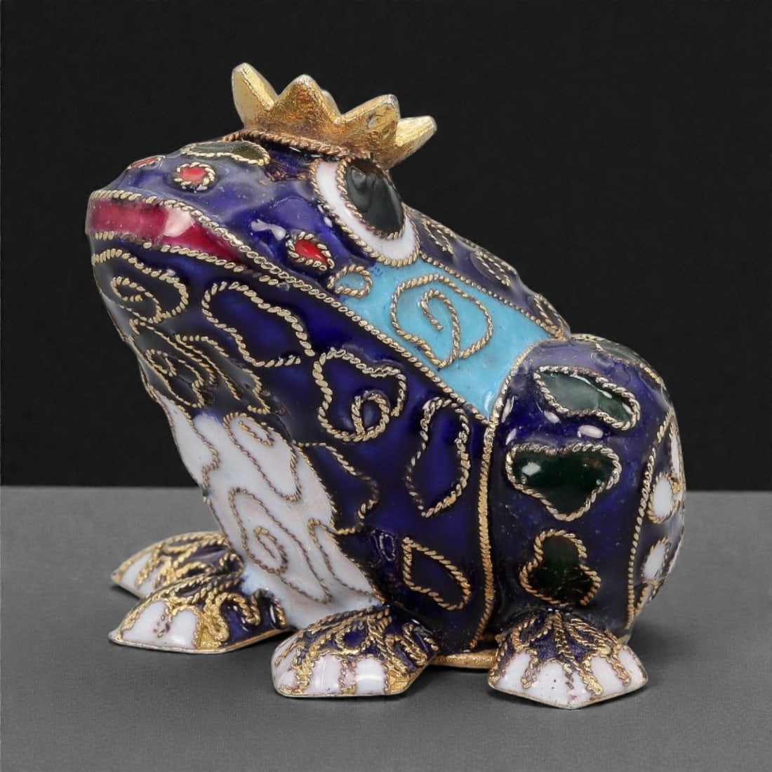 A Chinese Cloisonne Enamel Frog Effigy, 20th Century, 8FH: Modeled as a seated frog with the body upright and head raised, the effigy is constructed over a metal core and decorated overall with cloisonne enamel on a deep cobalt blue ground, the surface densel