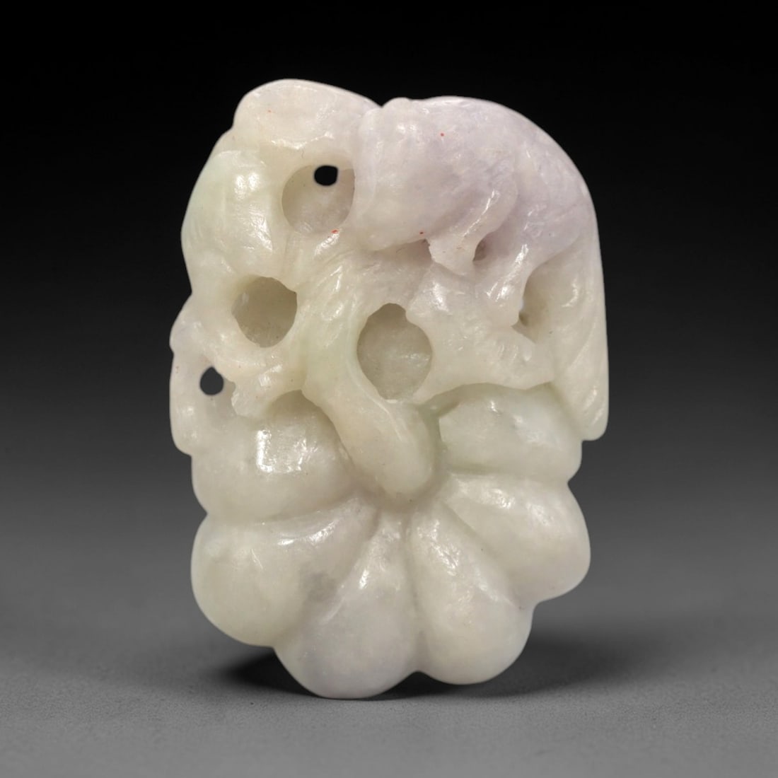 A Chinese Jadeite Jade Squirrel and Melon Pendant, 20th Century, 30FR: Carved from pale greenish-white jadeite jade with natural tonal variation and minor mineral inclusions, the pendant is executed in openwork relief. A squirrel is depicted atop a melon, with the creatu