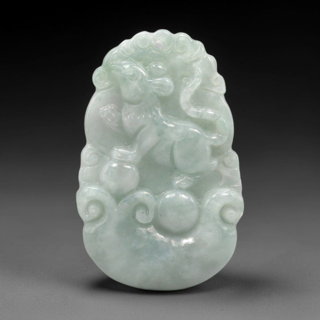 A Chinese Jadeite Rat Pendant, 20th Century, 100XL: Carved from pale green jadeite with subtle tonal variation and minor natural inclusions, the pendant is shaped in an irregular, slightly elongated form with a central suspension hole at the top. The s