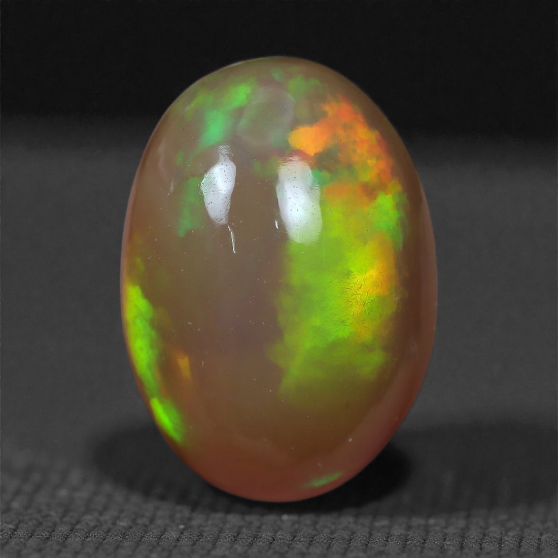 2.72 Carats Play-of-Color Welo Opal - Natural Ethiopian Gem 11x8mm, 30XC: This captivating Welo opal gleams with a luminous cascade of multi neon color that ripple across the stone's surface with every movement. The play-of-color is vivid and well-distributed, presenting a