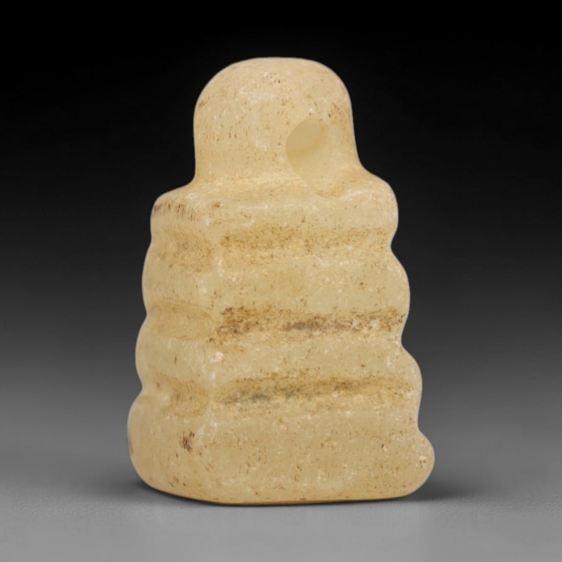 Ancient Calcite Djed Pillar Amulet - Egyptian Ritual Pendant, 63ZW: This amulet is carved from pale beige calcite, shaped in the iconic form of the Djed pillar, a symbol of stability and Osiris in ancient Egyptian religion. Four horizontal ridges define the pillar's s