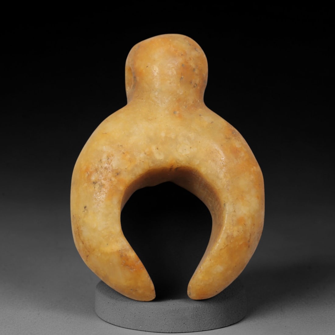 Ancient Cream Stone C-Shaped Pendant - Near Eastern Ritual Amulet, 8XQ: Carved from a smooth, creamy-tan stone with natural orange and grey mineral inclusions, this miniature pendant features a highly stylized C-shaped form, a distinctive geometric motif in ancient Near E