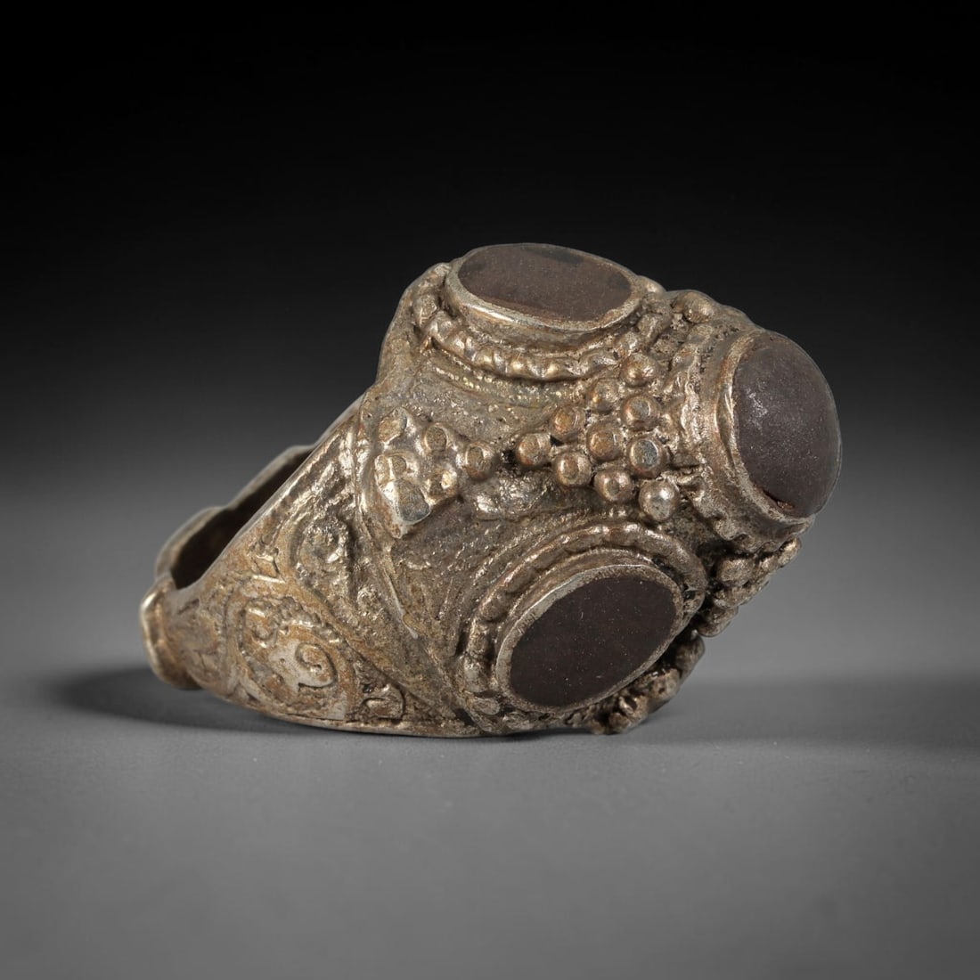 Antique Qajar Dynasty Silvered Multi-Stone Dome Ring - US Size 9, 64BA: This antique ring, crafted during the Qajar Dynasty of Persia, features an ornate domed bezel set with three empty oval settings, surrounded by intricate granulated and beaded metalwork. The shoulders