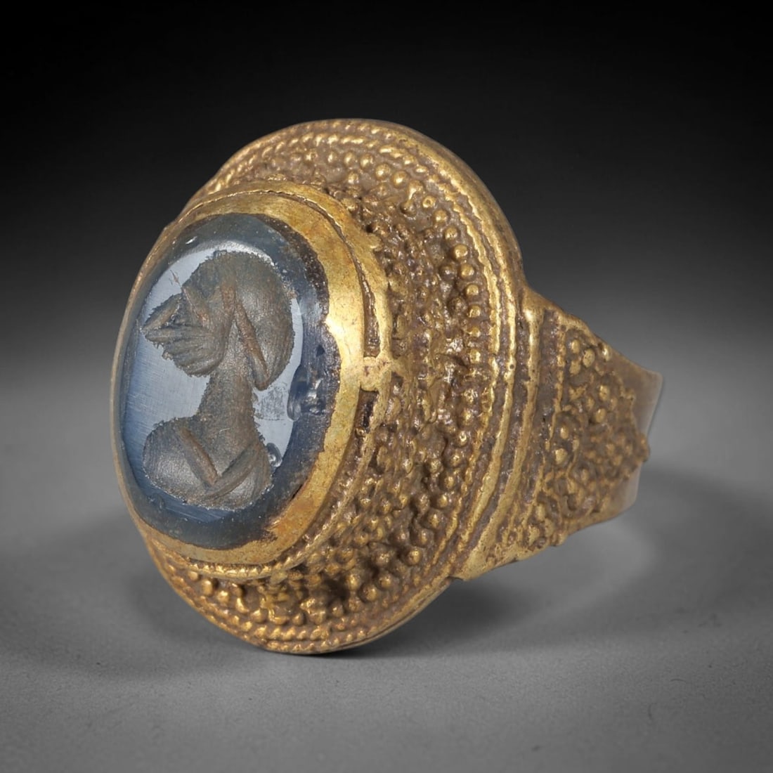 Antique Qajar Dynasty Brass Intaglio Ring - Size 8 US, 85BA: Crafted from brass, this ring features an intricately carved intaglio panel depicting a profile figure, executed in the distinctive Qajar style. The brass band exhibits a textured, granular granulatio