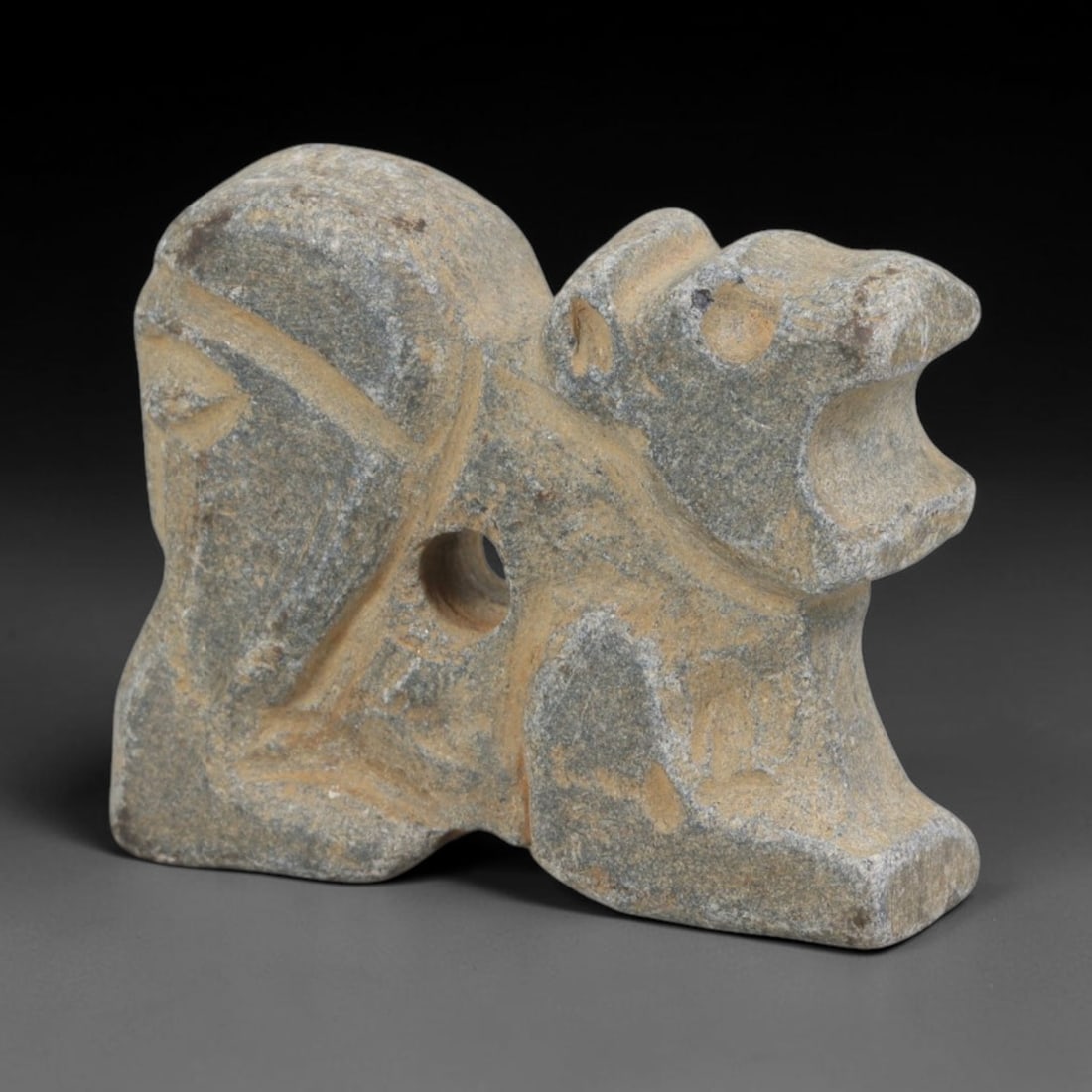 Ancient Schist Composite Zoomorphic Amulet - Near Eastern Carved Pendant, 69FY: Carved from schist, this amulet takes the form of a stylized, three-dimensional composite zoomorphic figure (a protective beast with dual symbolic features), rendered in bold, simplified carving. A ce