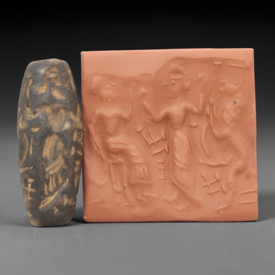 Ancient Steatite Cylinder Seal - Mesopotamian Narrative Scene, 87ZR: Carved from dense steatite, this ancient Mesopotamian cylinder seal features intricate linear relief depicting a complex narrative scene with multiple human figures in dynamic interaction, exemplifyin